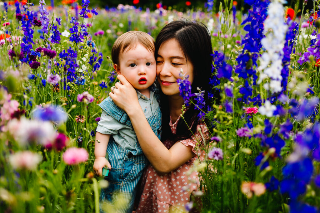 mother and son crouching in a wildflower field in Richardson Texas